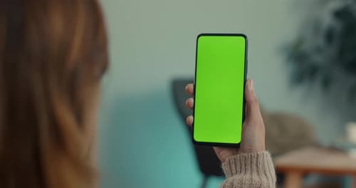 Woman Using Smartphoen with Green Screen at Home