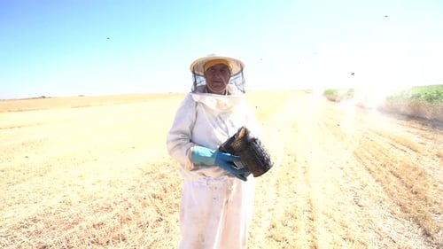 Beekeeper posing with bee smoker