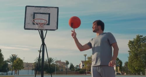Portrait of Male Basketball Player Spinning the Ball on Finger