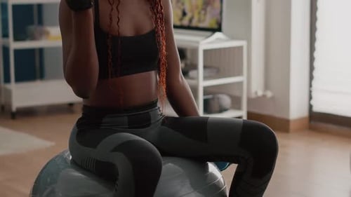 Woman Doing Arm Curls on Exercise Ball