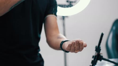 Man Adding White Powder to Hands