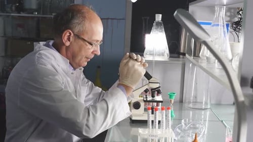 Concerned Scientist in Lab with COVID-19 Test Tubes