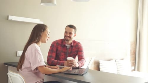 Young Couple Working on Laptop Together at Home