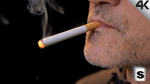 Close-up of Adult Lighting and Smoking Cigarette