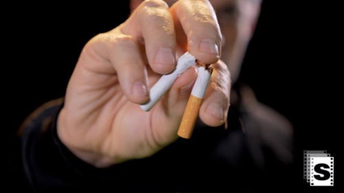 Man Breaks Cigarette in Half Close Up