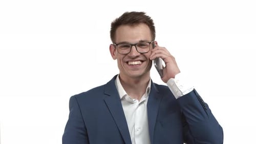 Young Adult Talks on Phone Wearing Suit and Glasses