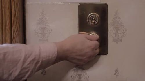 Hand Turns Vintage Light Switch to Dark