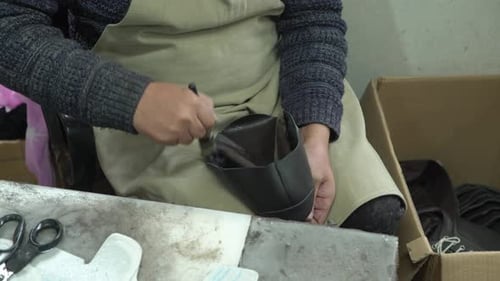 Shoemaker Assembling Leather Shoe in Workshop