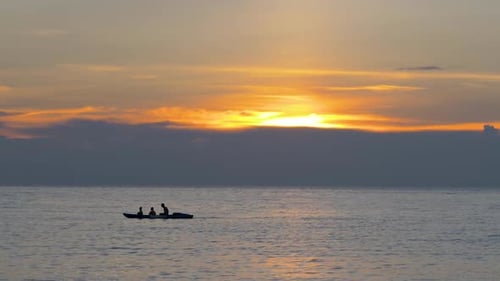 Silhouettes on Water at Sunset
