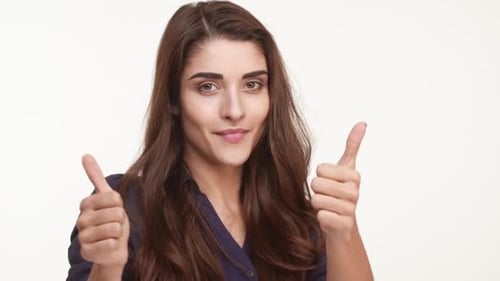 Smiling Beautiful Caucasian Female with Long Brown Hair Wearing Dark Blue Shirt Showing Ok with Two