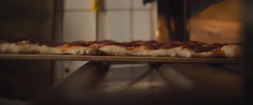 Putting Pizza in Pizza Oven With Peel