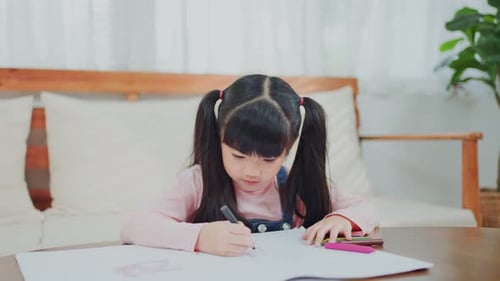 Girl Drawing with Marker at Indoor Table