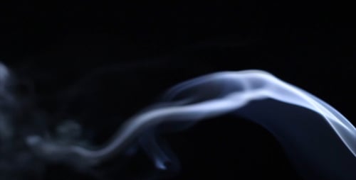 Blue Smoke Plumes Swirling Against Black Background
