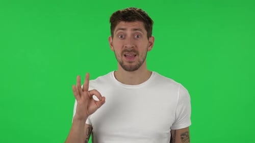 Man Giving OK Sign on Green Screen