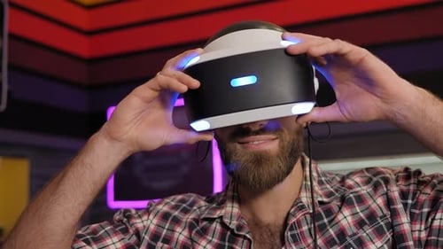Man Use a Virtual Reality Headset with Glasses in the Playroom