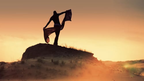 Woman Silhouette with Scarf on Sand Dune Sunset