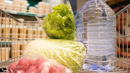 Various Products are Added to the Shopping Cart at the Supermarket