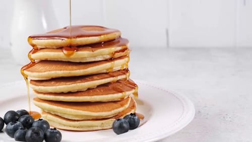 Delicious Stack of Pancakes with Maple Syrup
