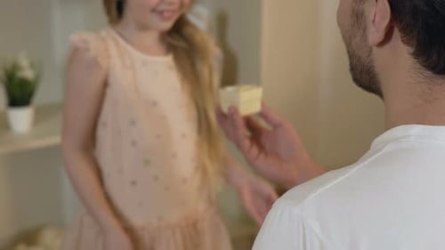 Happy Child Receiving Birthday Gift from Father