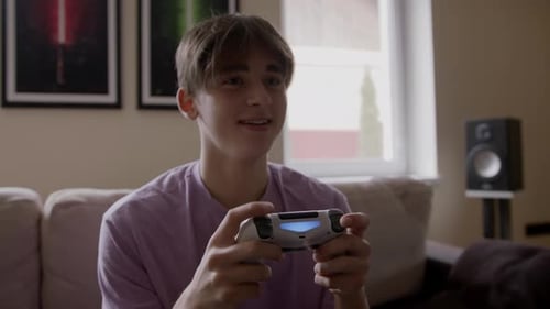 Teenage Boy Plays Video Games on Couch