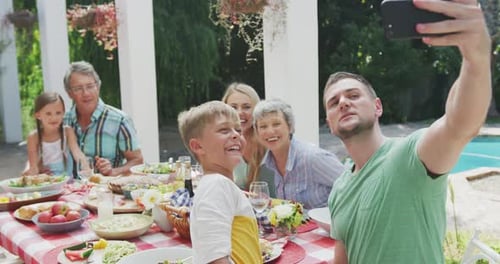 Family Gathering Taking a Selfie Outdoors on Sunny Day