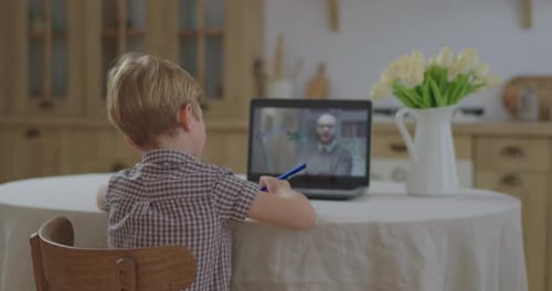 Preschool Kid Making Online School Homework with Teacher on Laptop Screen. Boy Studying Online at