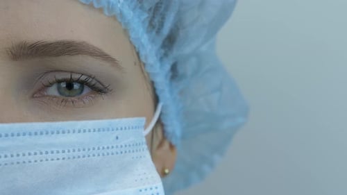 Woman Wearing Surgical Cap and Face Mask Close Up