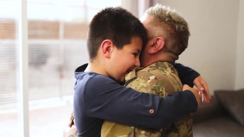 Heartwarming Reunion: Child Embraces Military Parent at Home