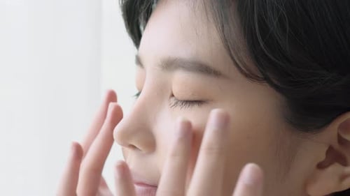 Woman Applies Makeup Around Eyes in Close Up