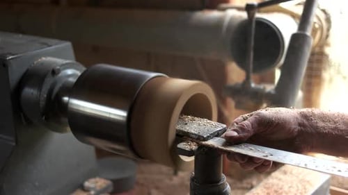 Carpenter Working with Equipment at His Workshop