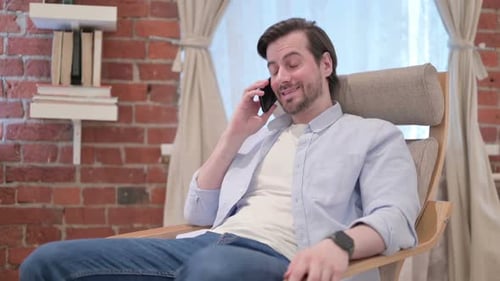 Man Chatting on Phone in Relaxed Setting