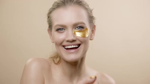 Young Woman Removes Eye Mask, Smiling