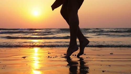 Barefoot Legs Walking on Beach at Sunset