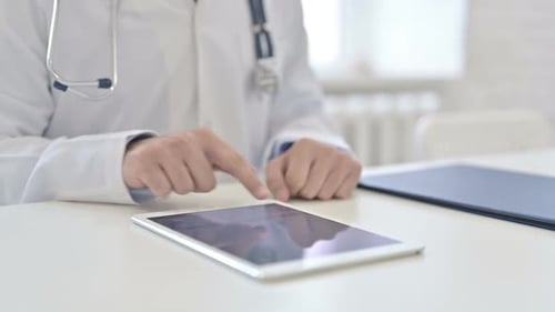 Doctor Using Tablet in Bright Office Environment