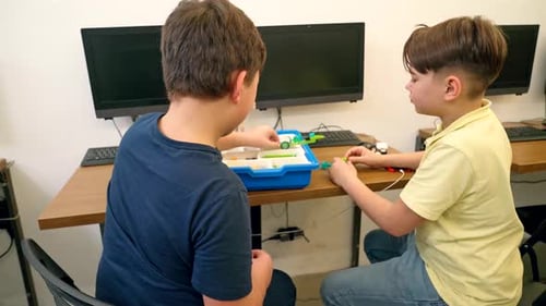 Male Young Friends Using Building Kit.