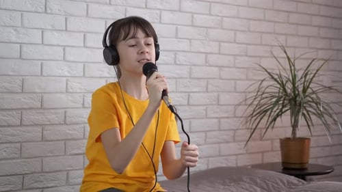 Enthusiastic Girl Singing into Microphone with Headphones