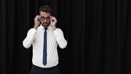 Young Adult Man Puts on Glasses and Smiles