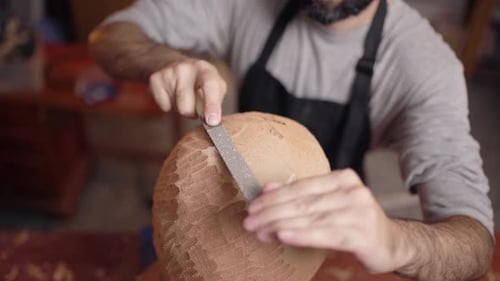 Man Carving Sculpture in Workshop Close Up
