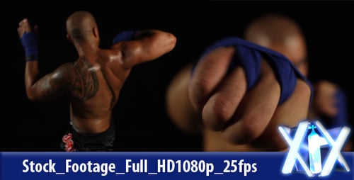 Focused Boxer Practicing Punches in a Dark Studio