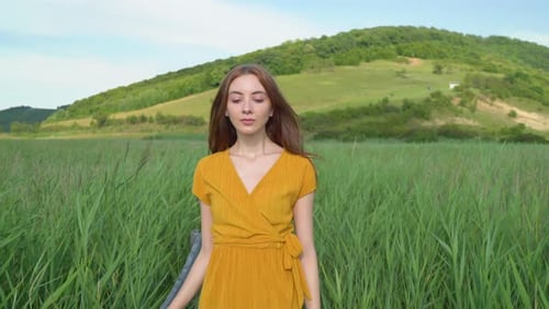 Woman walking in a reed field