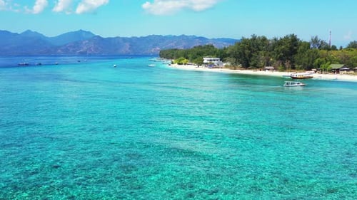 Beautiful sea texture of turquoise water on shallow lagoon with rocky sea bottom around white sandy