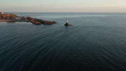 A drone flight at sunrise around the lighthouse in the port of Ahtopol