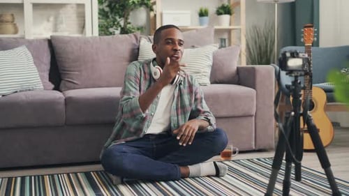Young Man Vlogging in Living Room at Home