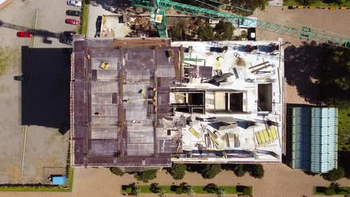 Building Construction And Workers From Top