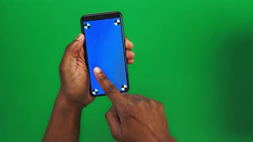 Closeup View of Two Black Male Hands Making Set of 17 Gestures on Smartphone Against Green Screen