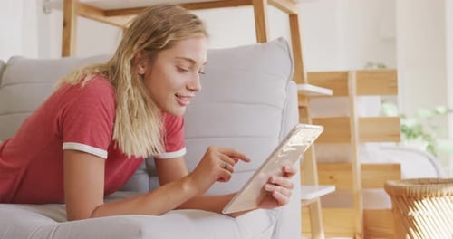 Young Woman Relaxing at Home with Tablet