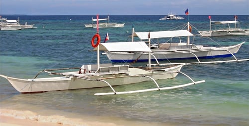 Outrigger Boats Resting on Tropical Beach