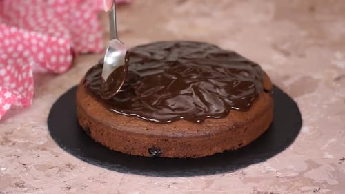 Icing Cake with Chocolate Frosting Close Up