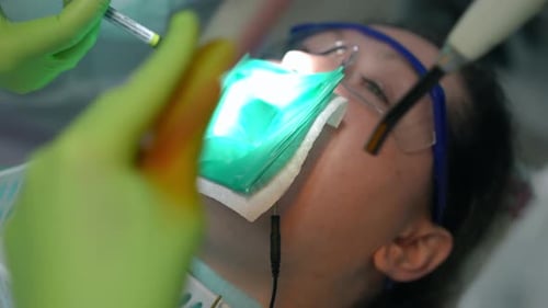 Dentist Performing Dental Procedure on Patient