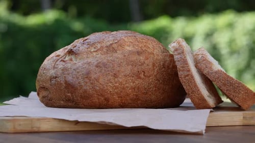 Crusty Bread Loaf and Slices on Board